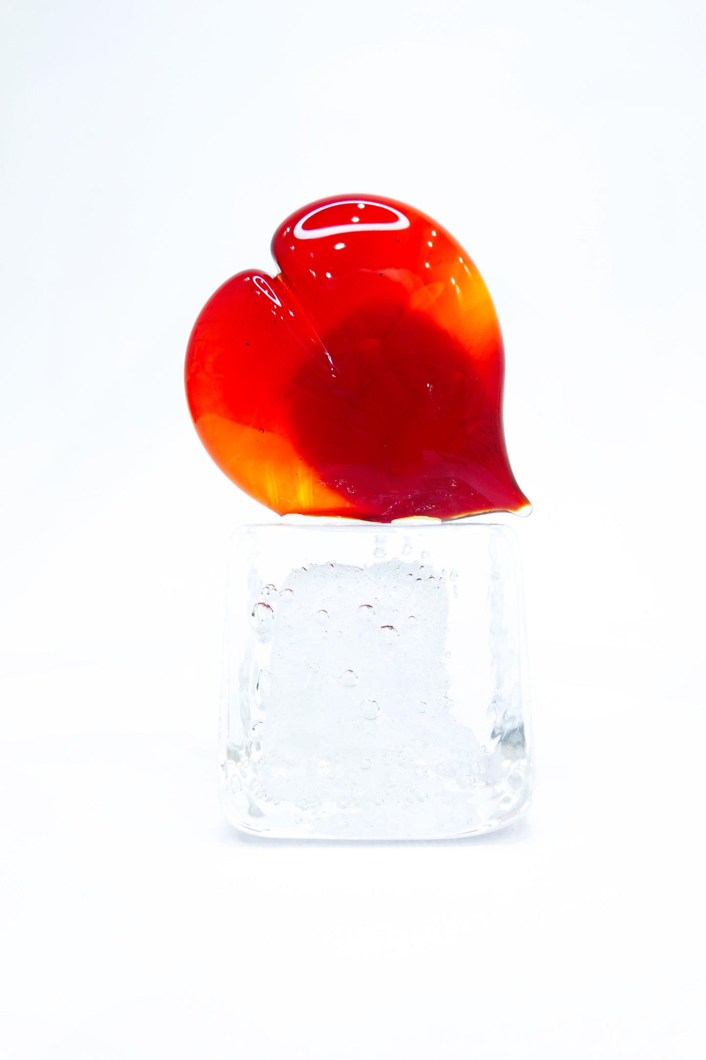 Red Heart in Murano glass on a transparent glass cube with bubbles