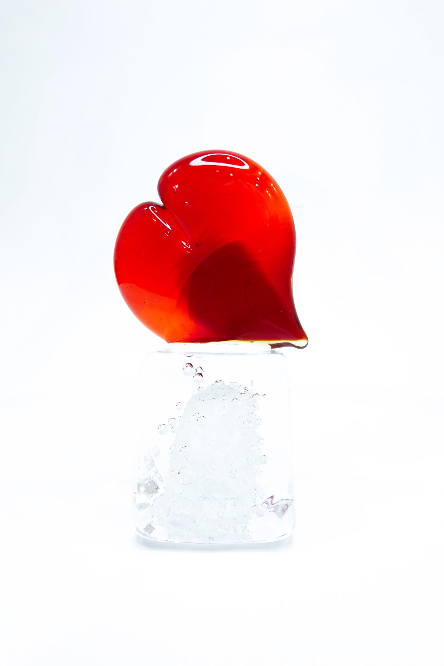 Red Heart in Murano glass on a transparent glass cube with bubbles