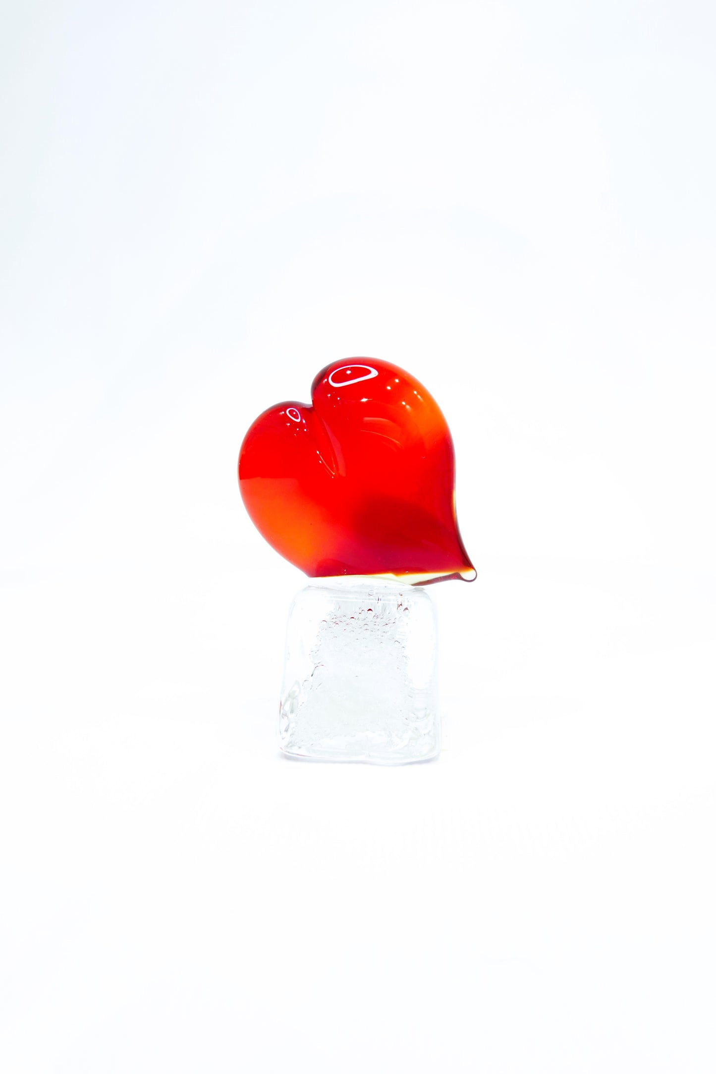 Red Heart in Murano glass on a transparent glass cube with bubbles